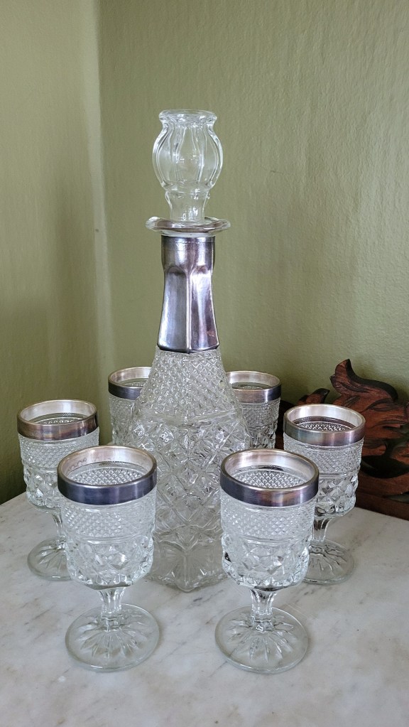 a silver-trimmed wine set, comprised of a Wexford wine decanter with silver-plated collar, and six silver-banded Wexford wine goblets