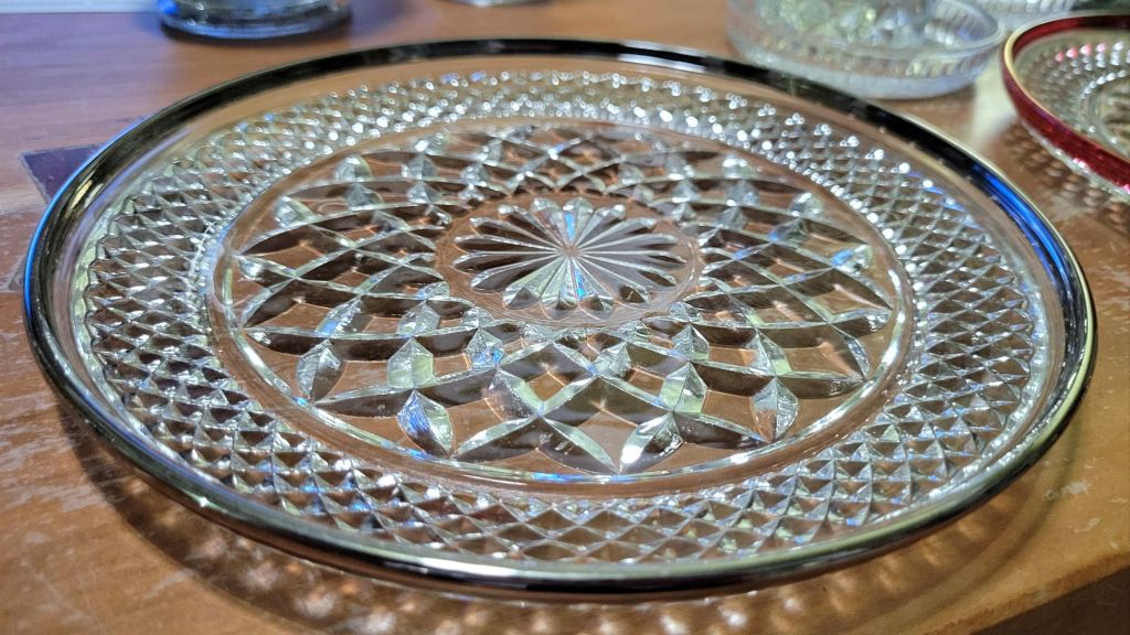 a single platinum-banded Wexford luncheon plate. pressed glass dinnerware, identified by the center daisy, the large diamond fill pattern, and the small diamond band flanked by narrow channels.