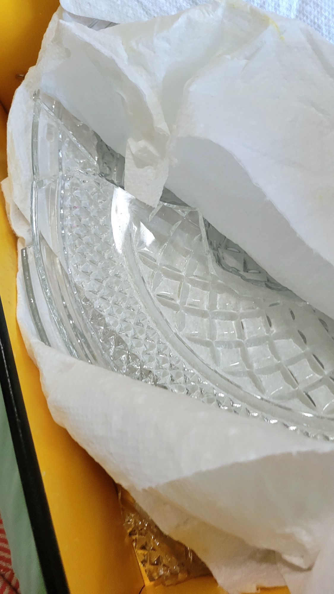 image of a shattered Wexford cake plate due to poor packing, showing a bottom box corner full of broken glass.