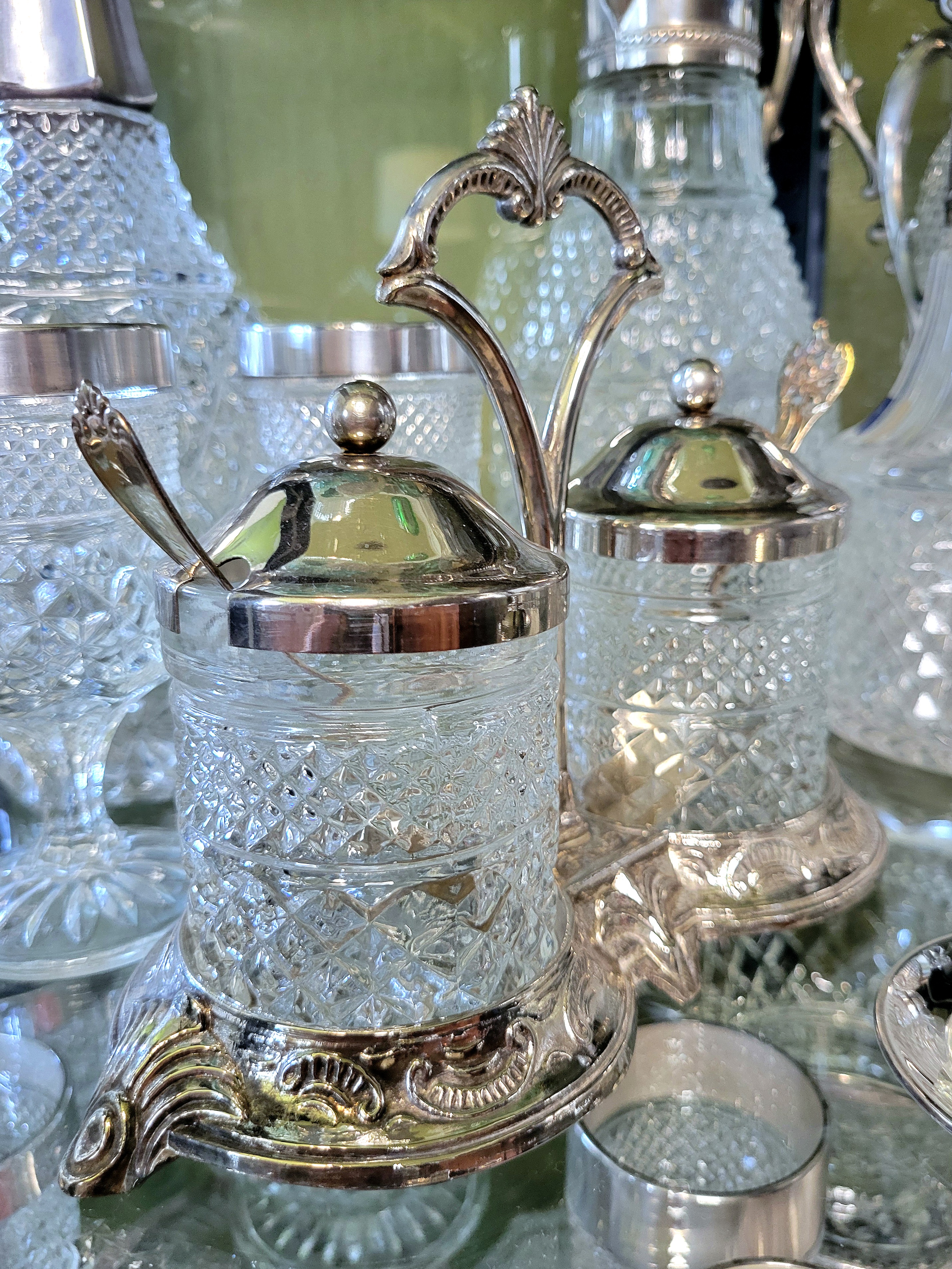a silver-plated servers with two Wexford lookalike glasses, silver-plated lids and spoons. most of the silver-plated lookalikes are European imports.