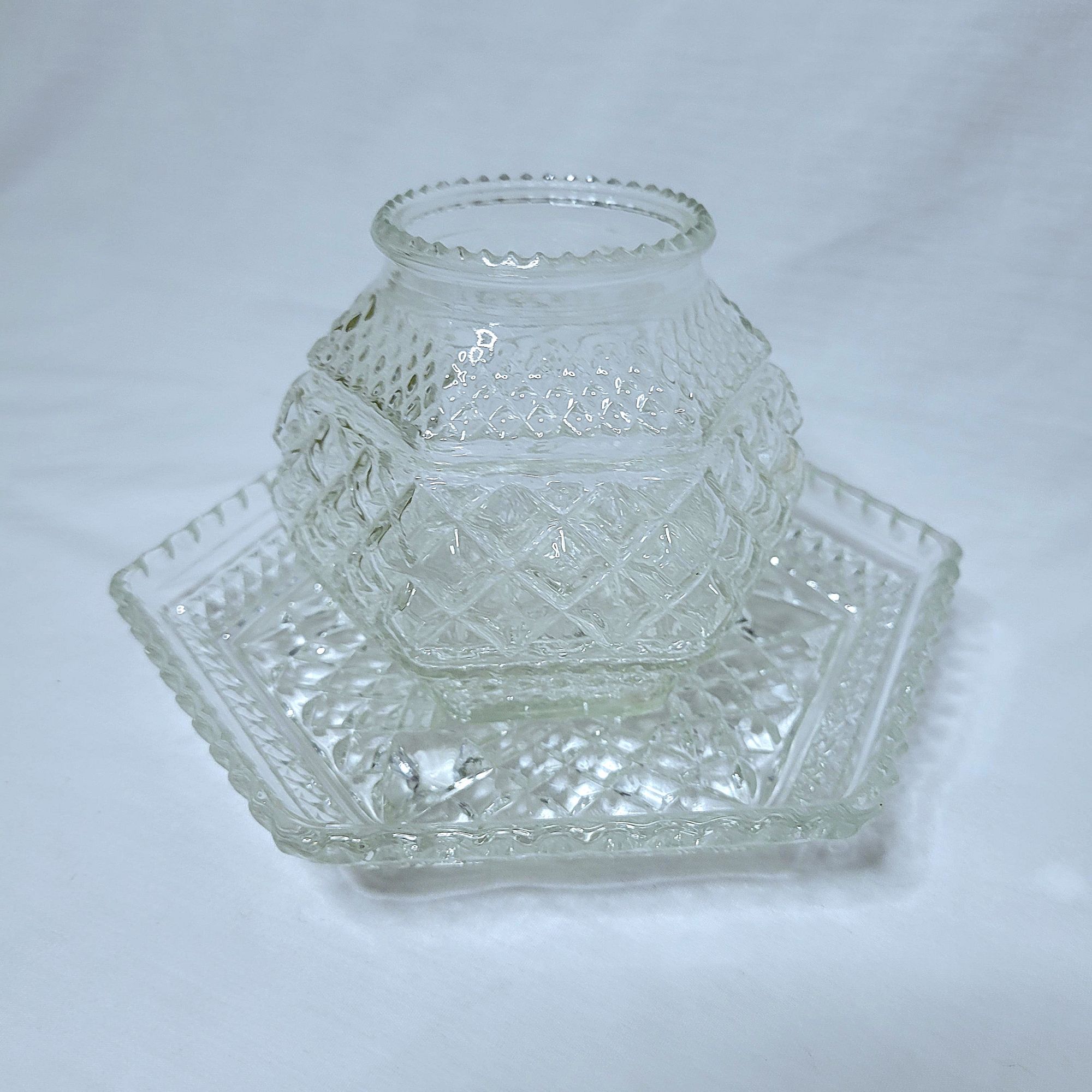 a grouping of Wexford vintage glassware by Anchor Hocking: a hexagonal plate and a lookalike candle bowl.