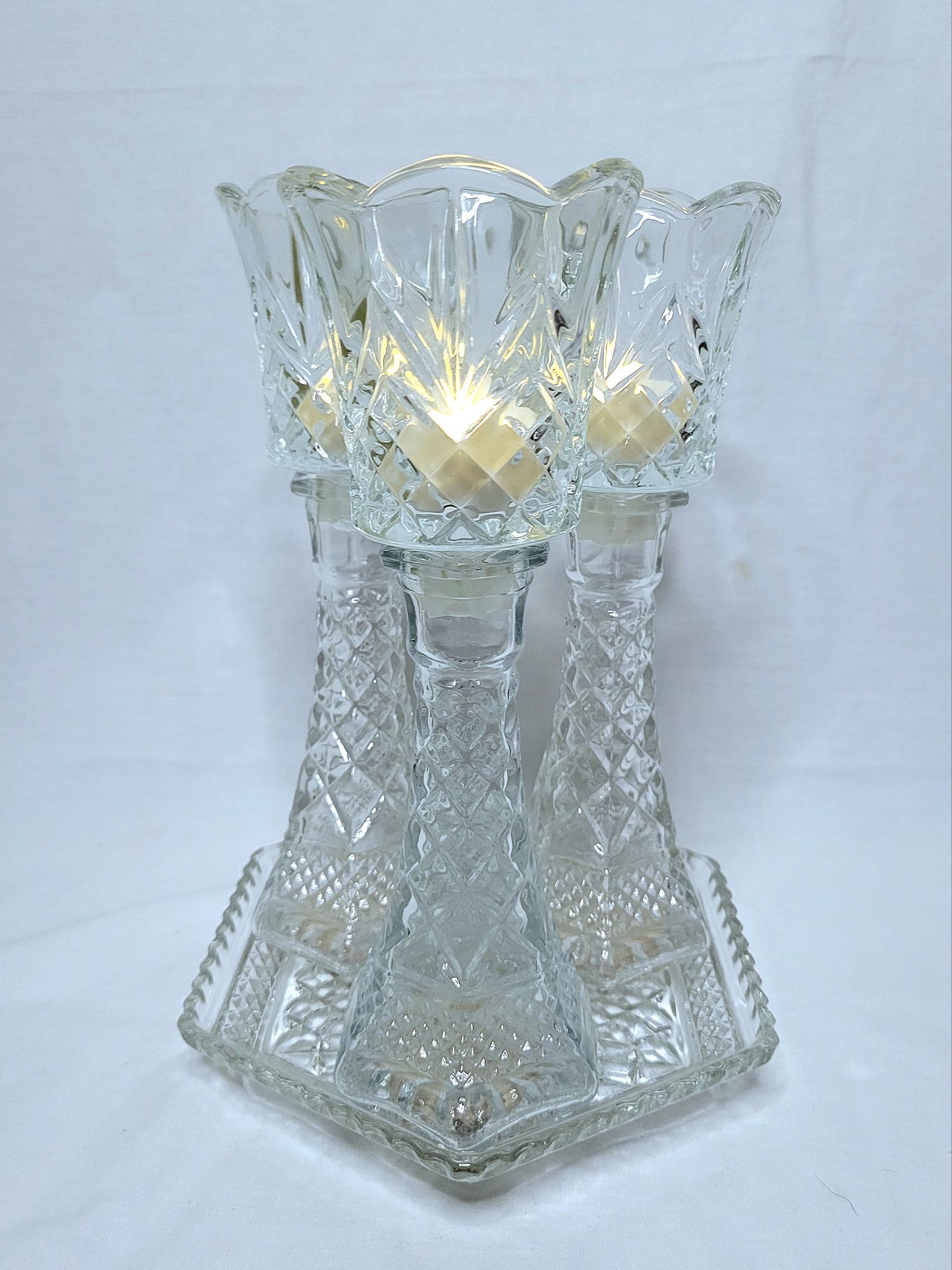 a grouping of Wexford vintage glassware by Anchor Hocking: a hexagonal plate with bud vase/candlesticks and peg votives with LED tealights.