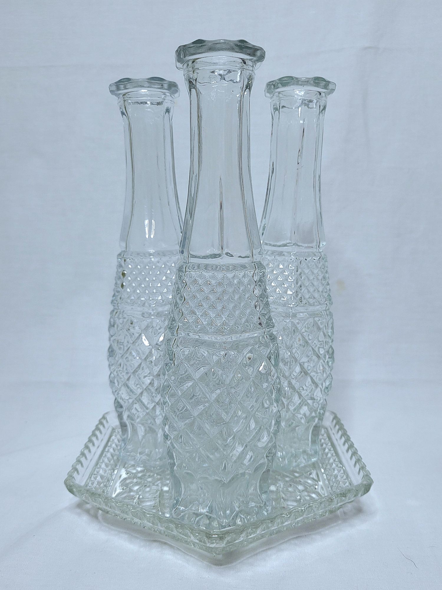 a grouping of Wexford vintage glassware by Anchor Hocking: a hexagonal plate with there bud vases.