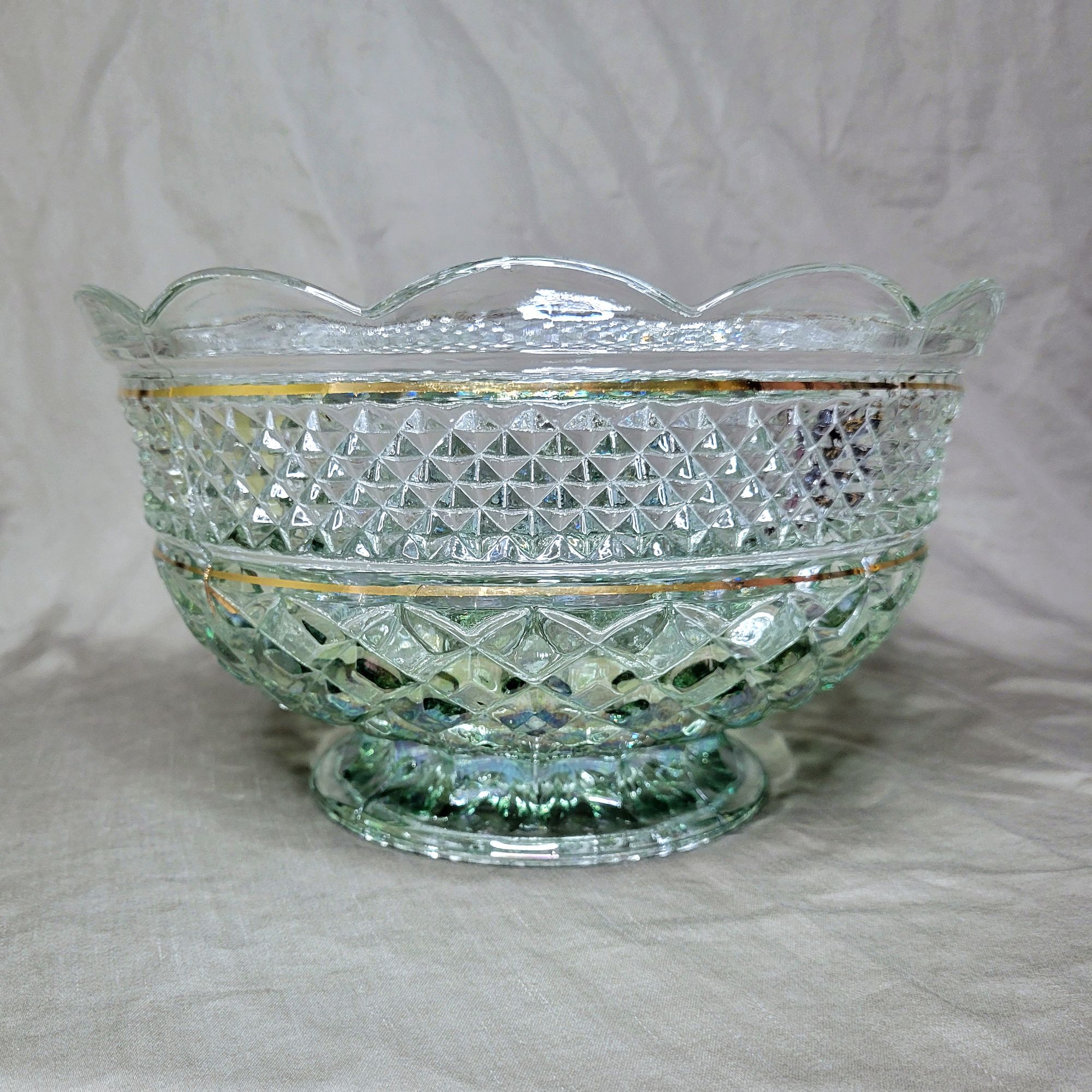 a large Wexford footed fruit bowl by Anchor Hocking, finished in an iridescent green ombre treatment and thin gold trim.
