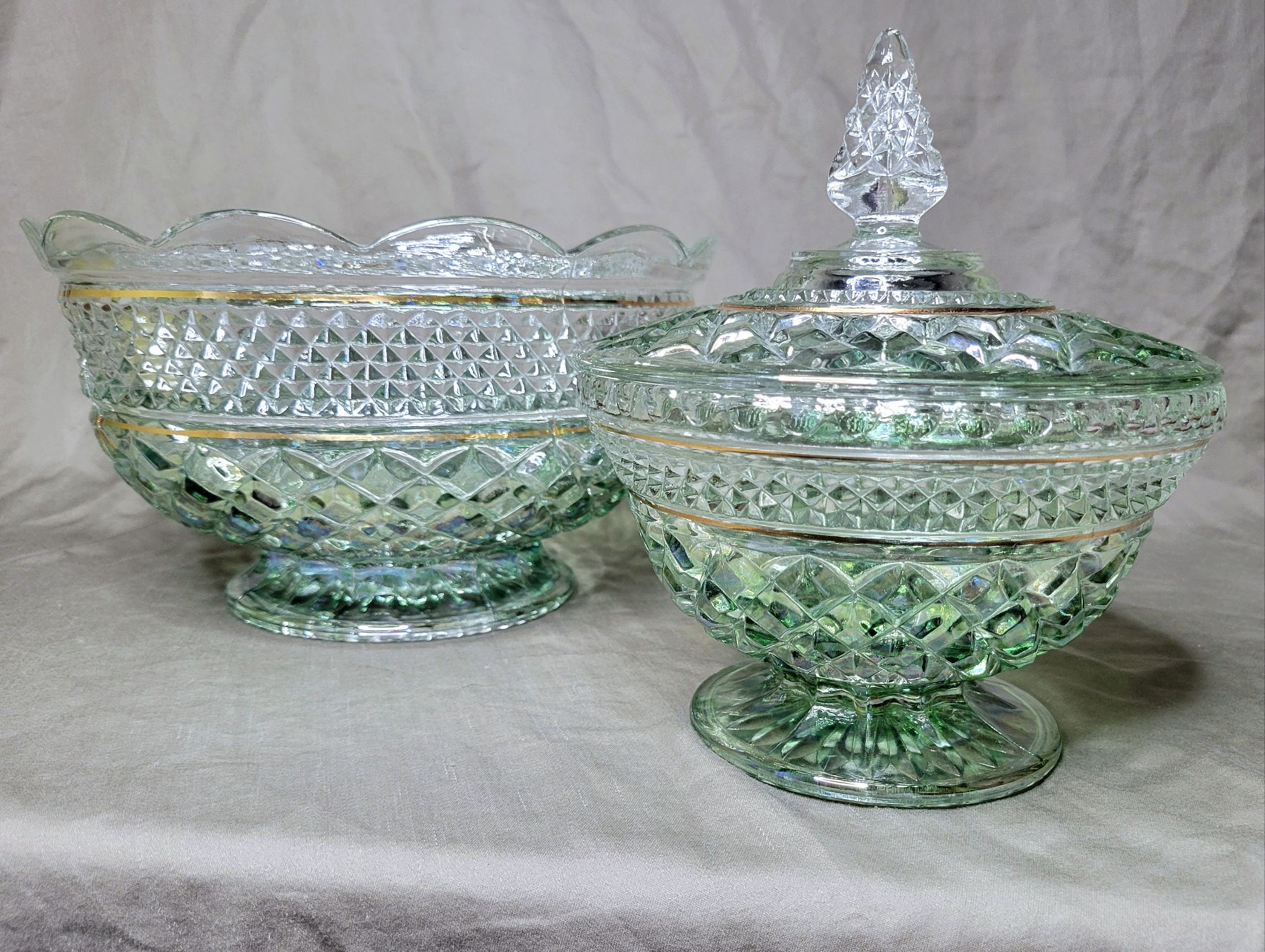 a large Wexford footed fruit bowl and lidded candy dish by Anchor Hocking, finished in an iridescent green ombre treatment and thin gold trim.