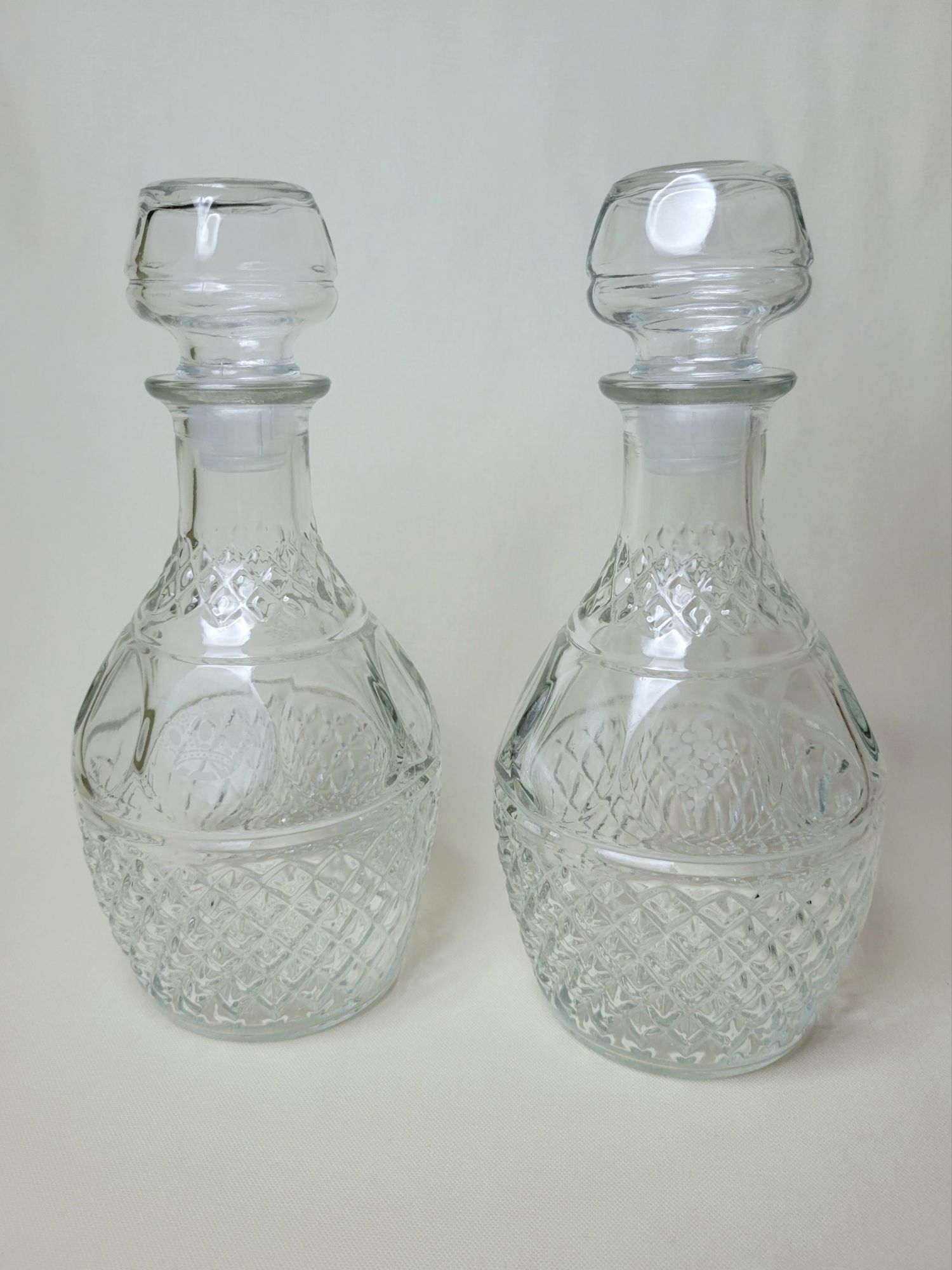 a pair of diamond pattern decanters.