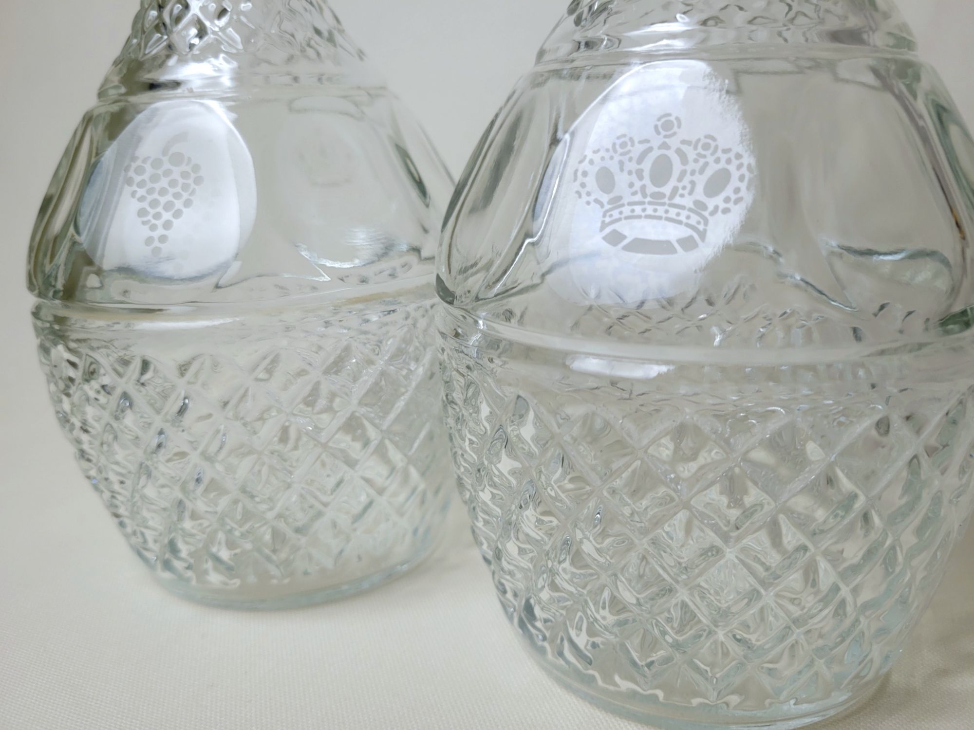 detail shot of the decanters, showing the etched details: a crown and a grape cluster