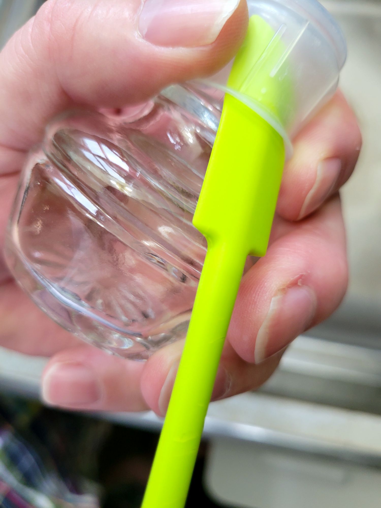 using a tiny silicone spatula as a prying tool to remove the gasket